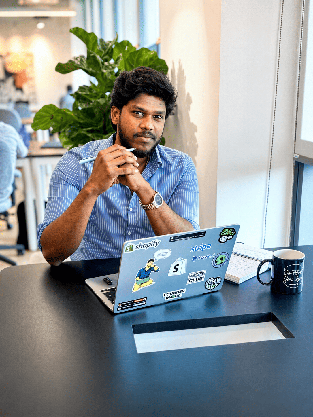 Manoj Chandran, Founder of Bcom2Ecom, working on a laptop